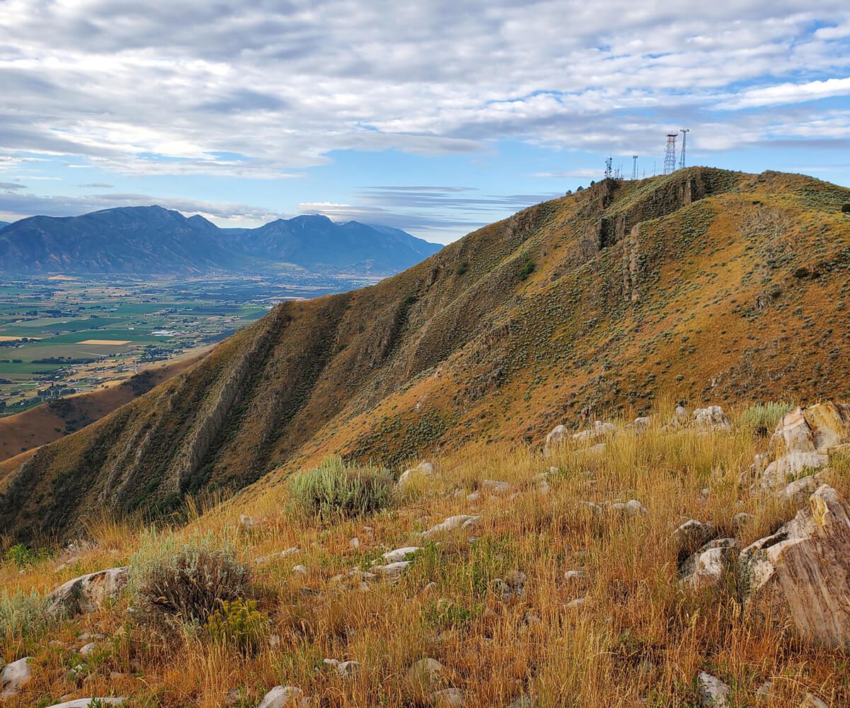 Mountain landscape with grassy hills and valley.