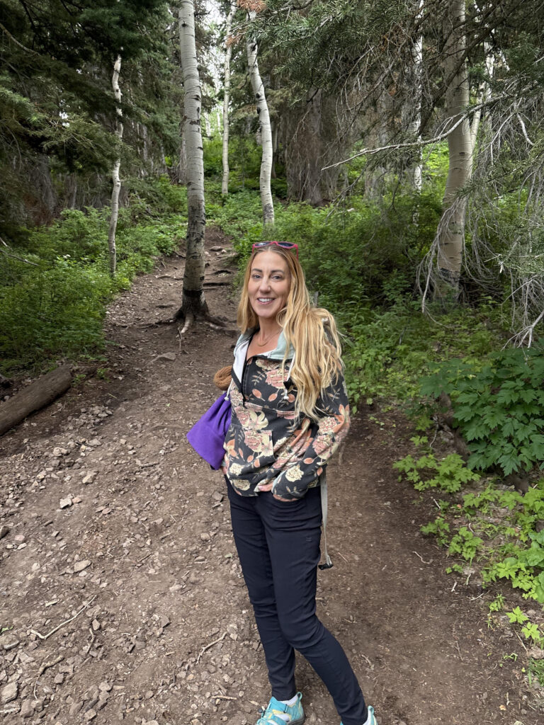 Smiling woman with long hair, outdoors.